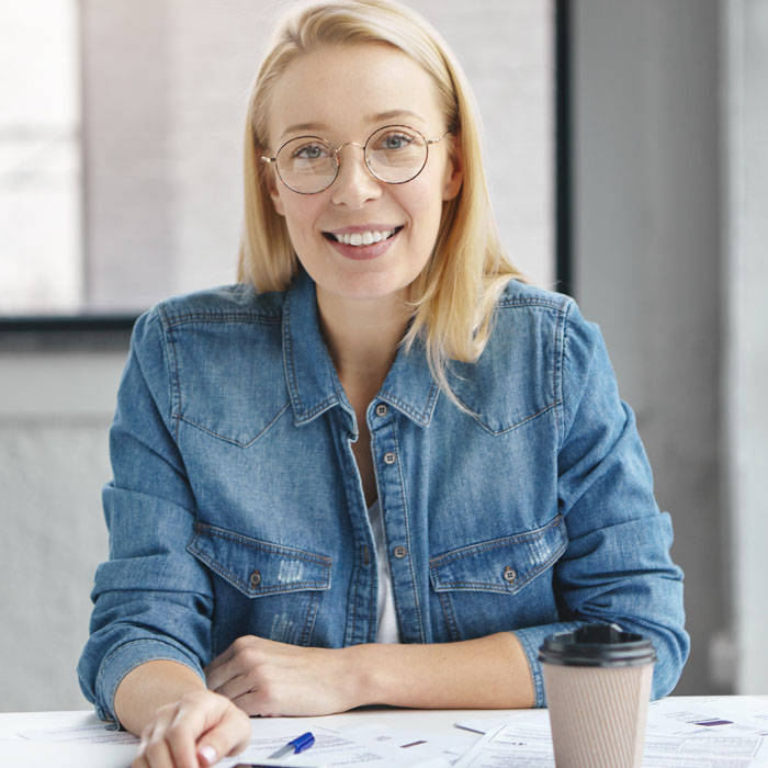 satisfied-blonde-female-in-eyewear-denim-shirt-stu-9TLMR4A.jpg